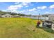 Grassy backyard features an outdoor grill, flowers, and other homes in the neighborhood at 589 Talisman Trail, Longs, SC 29568