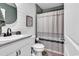 Well-lit bathroom features a vanity, mirror, and shower with a decorative curtain at 589 Talisman Trail, Longs, SC 29568