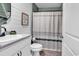 Well-lit bathroom features a vanity, mirror, and shower with a decorative curtain at 589 Talisman Trail, Longs, SC 29568