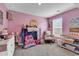 Bright pink bedroom with toys, decor, and a cozy chair at 589 Talisman Trail, Longs, SC 29568