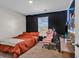 Cozy bedroom featuring a black accent wall, window and carpeted floor at 589 Talisman Trail, Longs, SC 29568