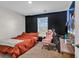 Cozy bedroom featuring a black accent wall, window and carpeted floor at 589 Talisman Trail, Longs, SC 29568