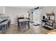 Dining area boasts a wooden table, decor shelves, and sliding glass doors, creating a bright and inviting space at 589 Talisman Trail, Longs, SC 29568