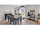 Dining area features a dark wood table, black chairs, sliding glass doors, and decor shelves with a rustic finish at 589 Talisman Trail, Longs, SC 29568