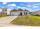 Charming one-story home with a well-manicured lawn and a two car attached garage at 589 Talisman Trail, Longs, SC 29568
