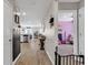 Inviting hallway with wood floors, leading to a kitchen and bedroom at 589 Talisman Trail, Longs, SC 29568