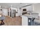 Stylish kitchen boasts white cabinets, stainless steel appliances, and a breakfast bar for casual dining at 589 Talisman Trail, Longs, SC 29568