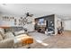 Bright living area with a comfortable sectional sofa, TV, ceiling fan, and decorative wall hangings at 589 Talisman Trail, Longs, SC 29568