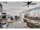 Open-concept living room with modern decor, connecting to the kitchen and dining area with lots of natural light at 589 Talisman Trail, Longs, SC 29568