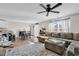 Cozy living area with a large sectional sofa, ceiling fan, open layout, and inviting natural light at 589 Talisman Trail, Longs, SC 29568