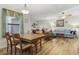 Bright dining area with a wooden table and chairs, adjacent to the living room at 611 S 13Th Ave. # 175, Surfside Beach, SC 29575