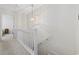 Upstairs hallway with carpeted floor, white railing, and light fixture at 611 S 13Th Ave. # 175, Surfside Beach, SC 29575