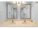 Double vanity bathroom with light blue walls and beige countertops at 7000 N Ocean Blvd. # 326, Myrtle Beach, SC 29572