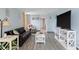Living room with gray floors, black couch, and white TV stand at 7000 N Ocean Blvd. # 326, Myrtle Beach, SC 29572