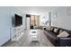 Bright living room with comfy sofa, flat-screen TV, and balcony access at 7000 N Ocean Blvd. # 326, Myrtle Beach, SC 29572