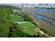 Aerial view of golf course with water and cityscape in the background at 711 Isle Verde Dr, Myrtle Beach, SC 29579