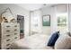 Guest bedroom with a dresser, closet and large windows at 711 Isle Verde Dr, Myrtle Beach, SC 29579