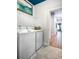 Clean laundry room with washer, dryer, and shelving at 711 Isle Verde Dr, Myrtle Beach, SC 29579