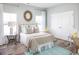 Comfortable bedroom with a cozy bed, accent mirror, and a calming color scheme at 718 Isle Verde Dr, Myrtle Beach, SC 29579