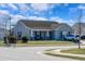 Corner lot single-story home with well-manicured lawn, sidewalk, and street sign in a quiet neighborhood at 801 Benchmade Rd., Conway, SC 29527