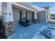 Covered front porch with stone pillars and wicker chairs, some snow on the ground at 801 Benchmade Rd., Conway, SC 29527