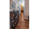 Hallway featuring hardwood flooring, a bookshelf, and access to a bathroom, creating a warm and inviting atmosphere at 801 Benchmade Rd., Conway, SC 29527