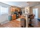 Open kitchen with stainless steel appliances, wood cabinets, hardwood floors, and breakfast bar seating at 801 Benchmade Rd., Conway, SC 29527