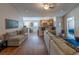 Open-concept living room with hardwood floors seamlessly connecting to the kitchen with a breakfast bar at 801 Benchmade Rd., Conway, SC 29527