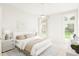 Bright bedroom boasts a ceiling fan, with plentiful natural light streaming through large windows at 910 Foxtail Dr. # D-45, Longs, SC 29568