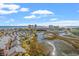 Breathtaking aerial view of a coastal community featuring beachfront homes, marshlands, and distant high-rise buildings under a blue sky at 9547 Edgerton Dr. # 606, Myrtle Beach, SC 29572