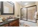Bathroom featuring granite counters, dark wood vanity, and tiled shower at 9547 Edgerton Dr. # 606, Myrtle Beach, SC 29572