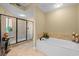 Bright bathroom featuring a glass-enclosed shower and a relaxing soaking tub at 9547 Edgerton Dr. # 606, Myrtle Beach, SC 29572