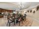 Elegant dining room features a decorative rug, a chandelier and unique starburst wall decor at 9547 Edgerton Dr. # 606, Myrtle Beach, SC 29572