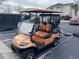 Orange golf cart parked in a parking lot at 9764 Leyland Dr. # 7, Myrtle Beach, SC 29572