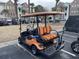 Rear view of an orange four-passenger golf cart at 9764 Leyland Dr. # 7, Myrtle Beach, SC 29572