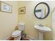 Clean and simple half bathroom with pedestal sink and oval mirror at 118 Seabreeze Dr., Murrells Inlet, SC 29576