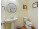 Well-appointed powder room with pedestal sink and hardwood floors at 118 Seabreeze Dr., Murrells Inlet, SC 29576