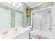 Green bathroom with shower/tub combo and vanity at 118 Seabreeze Dr., Murrells Inlet, SC 29576