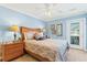 Blue bedroom with a queen bed and private balcony at 118 Seabreeze Dr., Murrells Inlet, SC 29576