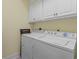 Functional laundry room with washer, dryer, and overhead cabinets at 118 Seabreeze Dr., Murrells Inlet, SC 29576