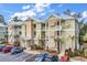 Green three-story building with balconies and parking at 130 Puffin Dr. # 3-E, Pawleys Island, SC 29585
