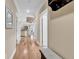Light-filled hallway with hardwood floors and bench at 130 Puffin Dr. # 3-E, Pawleys Island, SC 29585