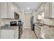 Modern kitchen with granite countertops and stainless steel appliances at 130 Puffin Dr. # 3-E, Pawleys Island, SC 29585