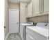 Laundry room with washer, dryer, and cabinets at 130 Puffin Dr. # 3-E, Pawleys Island, SC 29585