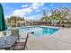 Community pool with lounge chairs and pond view at 130 Puffin Dr. # 3-E, Pawleys Island, SC 29585