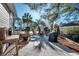 Backyard patio with mature trees, seating, and a grill at 1501 Brighton Ln., Longs, SC 29568