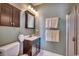 Bathroom featuring dark cabinetry, a glass-enclosed shower, and a tiled floor at 1501 Brighton Ln., Longs, SC 29568