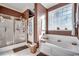 Bathroom with shower and bathtub, with a block window at 1501 Brighton Ln., Longs, SC 29568