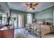 Bedroom with double doors to patio, ceiling fan, and tile floors at 1501 Brighton Ln., Longs, SC 29568