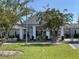 Welcoming clubhouse with a covered entrance, set amid manicured landscaping, offers a community gathering space at 1501 Brighton Ln., Longs, SC 29568